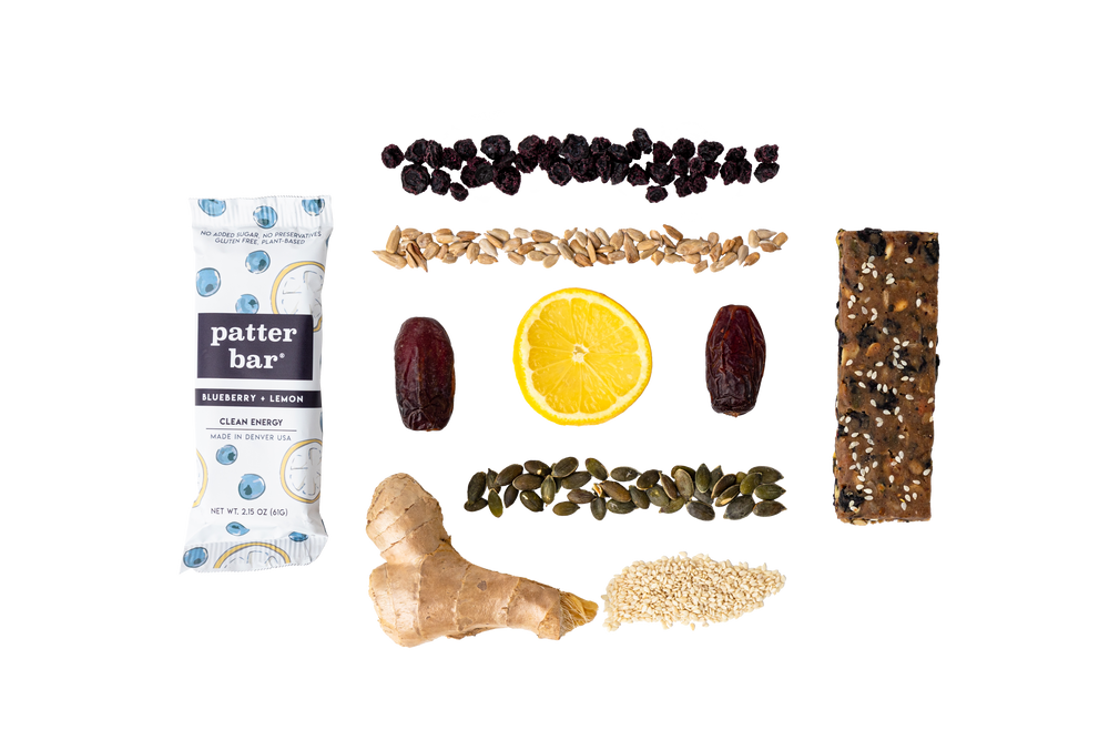 Ingredients for Blueberry Lemon Whole Food Energy Bar displayed: unsweetened, no oil added blueberries, roasted without oil or salt sunflower seeds, roasted without oil or salt pepitas, organic medjool dates, and lemon zest