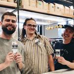 Image of smiling baristas holding Fruit Nut Seed, Coconut Cashew, and Blueberry Lemon Patterbars at Huckleberry Roasters on Wazee in Denver